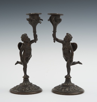 A Pair of Bronze Cherub Candlesticks 13269c