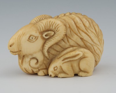 A Carved Ivory Netsuke of a Goat and