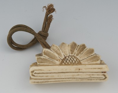 A Carved Bone Ojimi Suspended from