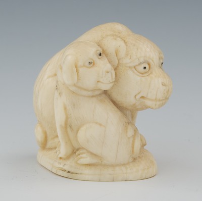 A Carved Ivory Netsuke of Two Dogs