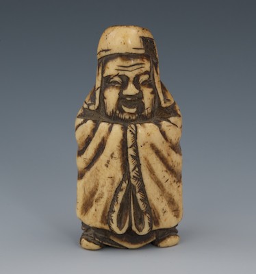 A Carved Staghorn Netsuke of Robed