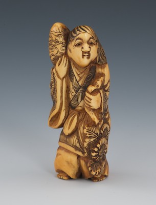 A Carved Ivory Netsuke of a Figure 132890