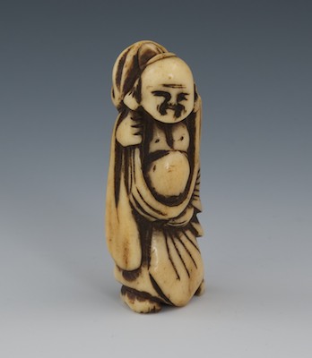 A Carved Staghorn Netsuke of Buddha