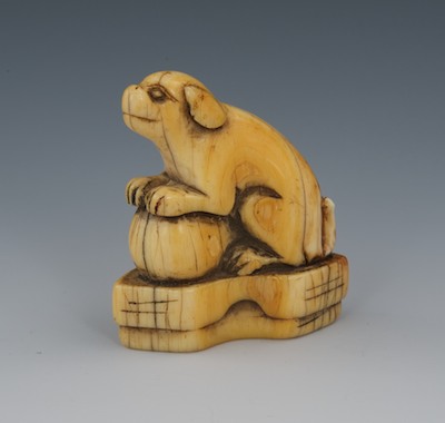 A Carved Ivory Netsuke of a Dog