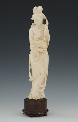 A Carved Ivory Attendant Holding