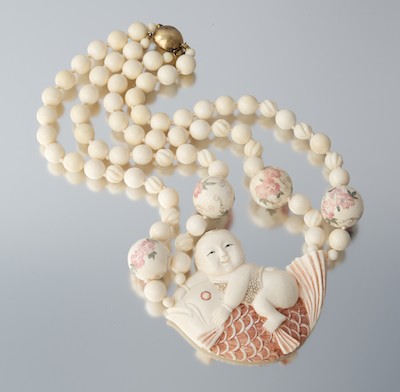 A Carved Ivory Necklace with Boy and