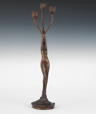 A Figural Bronze Candleholder After