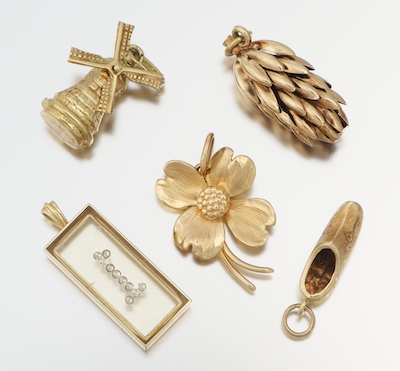 A Group of Five Gold Charms Containing: