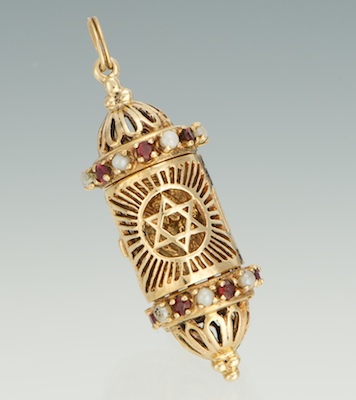 A Gold Mezuzah Pendant With Garnets