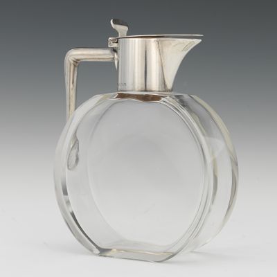 A Clear Glass Syrup Jug with Sterling