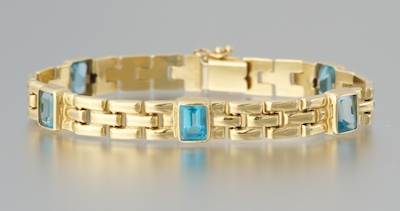 A Ladies' Blue Topaz and Gold Bracelet
