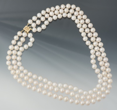 A Ladies' Triple Strand 9.5MM Pearl