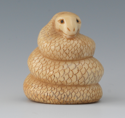 A Carved Ivory Netsuke of a Coiled 133659
