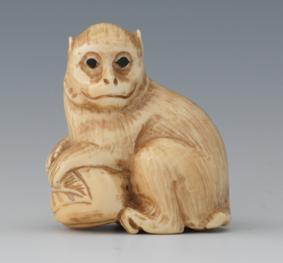 A Carved Ivory Netsuke of a Monkey