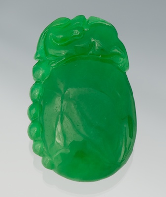 A Carved Green Jadeite Pendant