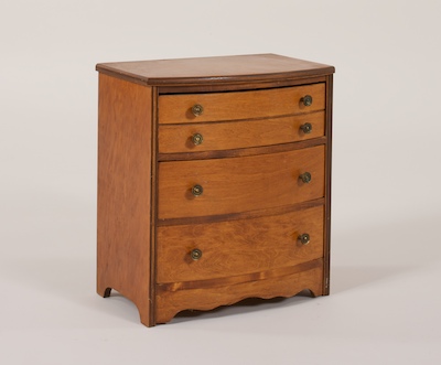 A Wooden Doll's Chest of Drawers