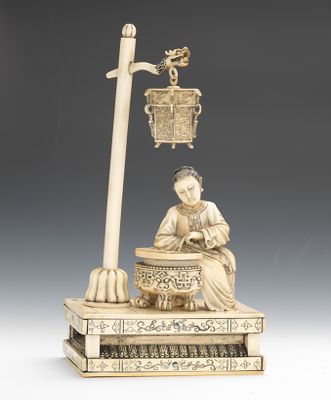 An Ivory Figural of a Woman Playing