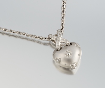 A Ladies Gold and Diamond Heart Pendant