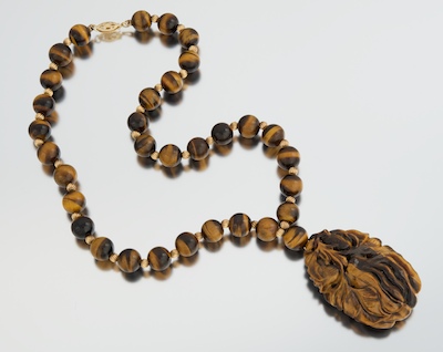 A Carved Tiger Eye Necklace with Pendant