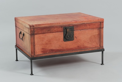 A Red Leather Trunk on a Steel Stand