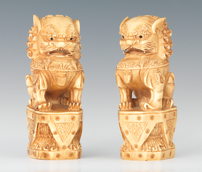 A Pair of Carved Ivory Foo Dogs