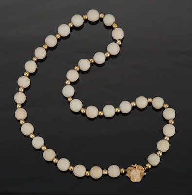 A Carved White Coral Bead Necklace