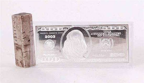 Silver bar and 100 dollar bill