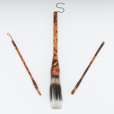 Three Tortoise clad brushes A large