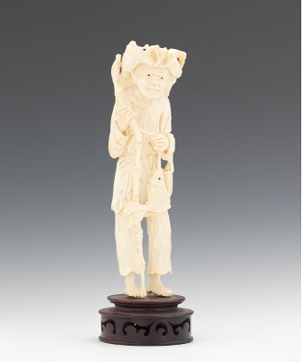 A Carved Ivory Statuette of a Fisherman