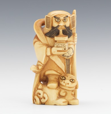 A Carved Ivory Statuette of a Figure