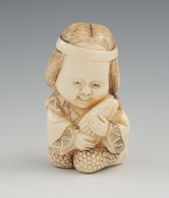 A Carved Ivory Netsuke of a Child