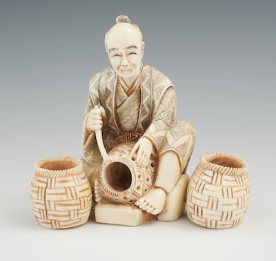 A Carved Ivory Figure of a Basket 13401b