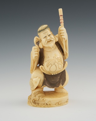 A Carved Ivory of a Fisherman Carved