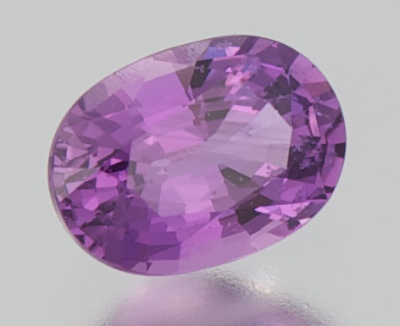 An Unmounted Purple Sapphire Oval