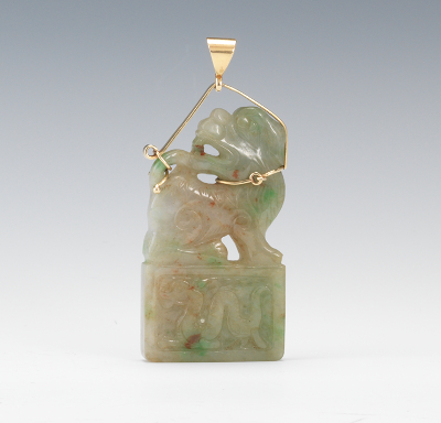 A Carved Jade Foo Dog Pendant in