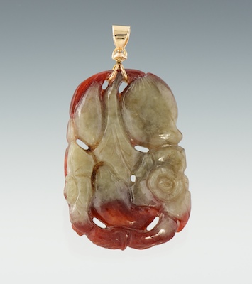 A Carved Jade and Gold Pendant