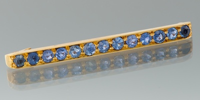 A Gold and Sapphire Bar Brooch
