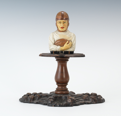 A Football Figural Pipe Rest Comprised