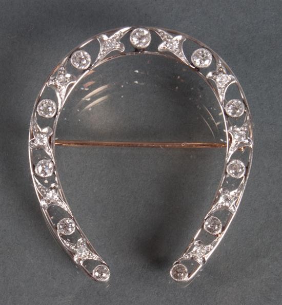 Diamond horse shoe-form brooch