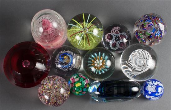 Twelve assorted glass paperweights