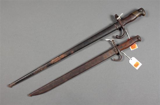 Two bayonets with scabbards one is French