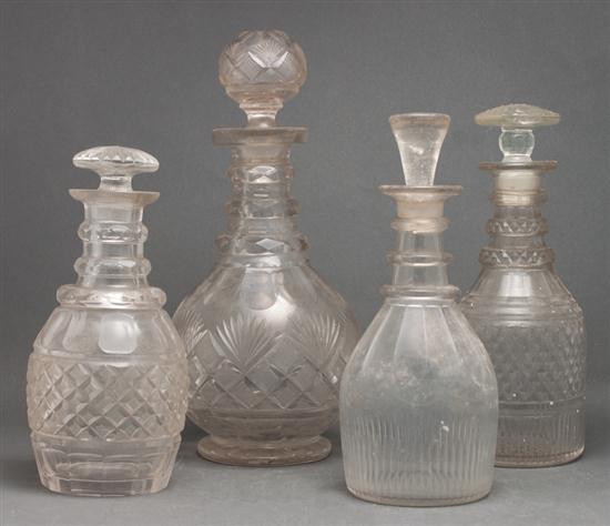 Four assorted colorless glass decanters