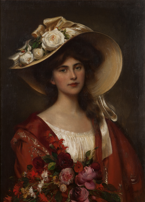 Portrait of a young woman in a hat holding
