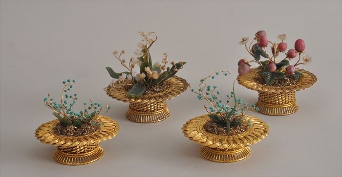 FOUR SILVER GILT BASKETS FILLED WITH