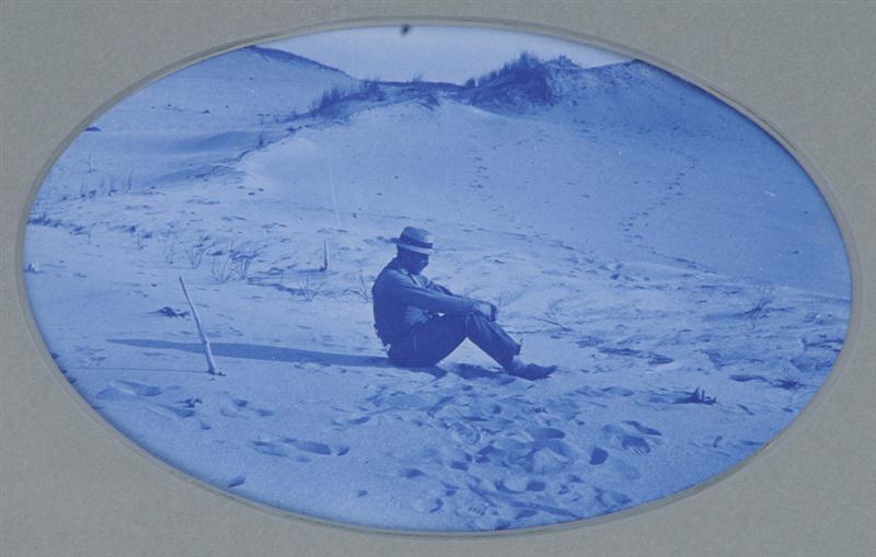 UNKNOWN C.1890: MAN RESTING IN SAND