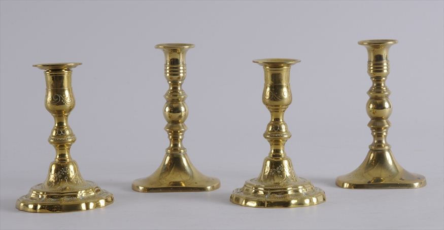 TWO PAIRS OF BRASS CANDLESTICKS