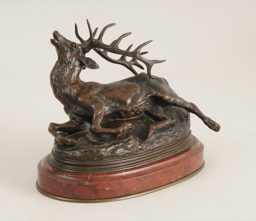 BRONZE MODEL OF A STAG Raised on a red