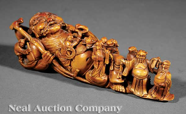 A Chinese Carved and Stained Ivory Figure