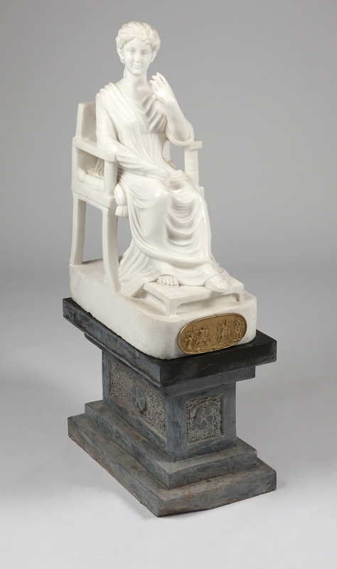 A white marble statue of a classical