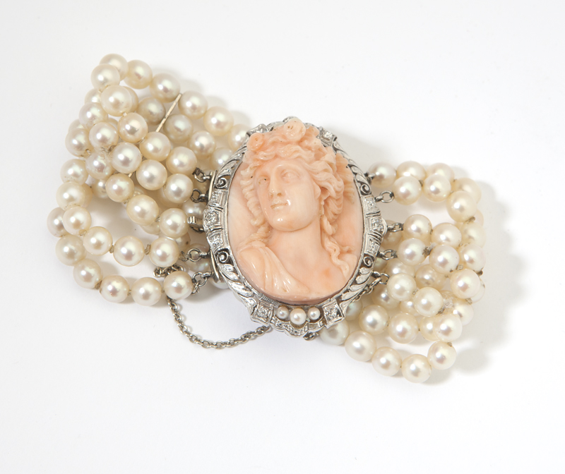 A carved coral and platinum cameo 142300